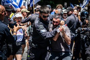 A police officer detains a protester during a demonstration. Demonstrators call on Israeli Prime Minister Benjamin Netanyahu to end the war in Gaza and to release all 50 Israeli hostages held by Hamas since October 7, 2023. On what was the biggest day of national mobilization, hundreds of thousands of people poured into the streets around the country to demand a Hostage release deal and an end to the war in Gaza.