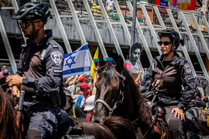 Protestors face horse-mounted police officers and hold up a cutting showing Israeli hostage Matan Zangauker during a demonstration. Demonstrators call on Israeli Prime Minister Benjamin Netanyahu to end the war in Gaza and to release all 50 Israeli hostages held by Hamas since October 7, 2023. On what was the biggest day of national mobilization, hundreds of thousands of people poured into the streets around the country to demand a Hostage release deal and an end to the war in Gaza.