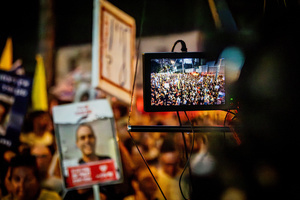 A monitor shows protesters gathered during a demonstration. Demonstrators call on Israeli Prime Minister Benjamin Netanyahu to end the war in Gaza and to release all 50 Israeli hostages held by Hamas since October 7, 2023. On what was the biggest day of national mobilization, hundreds of thousands of people poured into the streets around the country to demand a Hostage release deal and an end to the war in Gaza.
