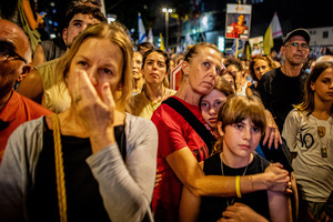 A mother holds her children during a demonstration. Demonstrators call on Israeli Prime Minister Benjamin Netanyahu to end the war in Gaza and to release all 50 Israeli hostages held by Hamas since October 7, 2023. On what was the biggest day of national mobilization, hundreds of thousands of people poured into the streets around the country to demand a Hostage release deal and an end to the war in Gaza.