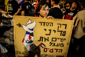 An Israeli woman holds a placard calling for a two state solution during the demonstration. Demonstrators call on Israeli Prime Minister Benjamin Netanyahu to end the war in Gaza and to release all 50 Israeli hostages held by Hamas since October 7, 2023. On what was the biggest day of national mobilization, hundreds of thousands of people poured into the streets around the country to demand a Hostage release deal and an end to the war in Gaza.