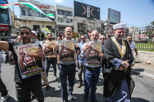 Protesters hold pictures of Palestinian prisoner Marwan Barghouti, who is serving five life sentences plus 40 years in an Israeli prison, during a protest demanding his release and the release of all prisoners in the city of Nablus. Marwan Barghouti, 66, is considered the most popular Palestinian leader and a fierce opponent of Israel. He has consistently advocated for a two-state solution.