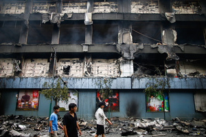 People walk past a devastated supermarket after the Gen Z protests in Kathmandu, Nepal, on Wednesday, September 10, 2025, the third day of an army-imposed curfew. The demonstrations, sparked by anger over corruption, the social media ban, and the killing of more than 19 youths, led to the resignation of Prime Minister K.P. Sharma Oli. The country remains under army control amid escalating unrest.