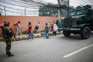 Prisoners are escorted back to jail after attempting to escape by setting the facility on fire after the Gen Z protests in Kathmandu, Nepal, on Wednesday, September 10, 2025, the third day of an army-imposed curfew. The demonstrations, sparked by anger over corruption, the social media ban, and the killing of more than 19 youths, led to the resignation of Prime Minister K.P. Sharma Oli. The country remains under army control amid escalating unrest.
