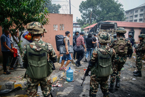 Prisoners are escorted back to jail after attempting to escape by setting the facility on fire after the Gen Z protests in Kathmandu, Nepal, on Wednesday, September 10, 2025, the third day of an army-imposed curfew. The demonstrations, sparked by anger over corruption, the social media ban, and the killing of more than 19 youths, led to the resignation of Prime Minister K.P. Sharma Oli. The country remains under army control amid escalating unrest.