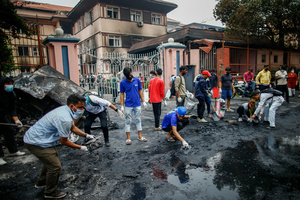 Youths clean up the streets outside the Supreme Court following the Gen Z protests in Kathmandu, Nepal, on Wednesday, September 10, 2025, the third day of an army-imposed curfew. The demonstrations, fueled by anger over corruption, the social media ban, and the killing of more than 19 youths, forced Prime Minister K.P. Sharma Oli to resign. The country remains under army control amid ongoing unrest.