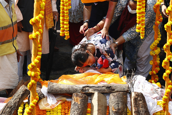 The wife of Assistant Sub-Inspector Milan Raya who was brutally killed during the Gen Z protests holds the hand before his cremation at Pashupatinath Temple. The Police performed a guard of honor. It marks the fifth day of an army-imposed curfew during which more than 51 people have been killed. The Gen Z protests fueled by anger over corruption and the social media ban forced Prime Minister K.P. Sharma Oli to resign.