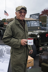 A US tank mechanic reenactor poses for a portrait. The Tank Museum's Tiger Day is a biannually event at Bovington camp showcasing German Tiger 131, the only operational Tiger I tank in the world, it also features other World War II-era tanks including M4A2E8 Sherman "Fury", M3 Grant and the British Churchill tank. The event included a reenactment of the Battle of "Capture the Tiger", demonstrating how the Tiger 131 was captured on 24th April 1943 in Tunisia by 42nd Battalion Royal Armored Corps and 2nd Sherwood Foresters.