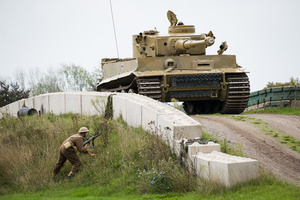 A British solider attempts to attack the Tiger 131 during the Battle of "Capture the Tiger" reenactment. The Tank Museum's Tiger Day is a biannually event at Bovington camp showcasing German Tiger 131, the only operational Tiger I tank in the world, it also features other World War II-era tanks including M4A2E8 Sherman "Fury", M3 Grant and the British Churchill tank. The event included a reenactment of the Battle of "Capture the Tiger", demonstrating how the Tiger 131 was captured on 24th April 1943 in Tunisia by 42nd Battalion Royal Armored Corps and 2nd Sherwood Foresters.