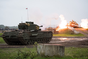 A Churchill tank "fires" at the Tiger 131 during the Battle of "Capture the Tiger" reenactment. The Tank Museum's Tiger Day is a biannually event at Bovington camp showcasing German Tiger 131, the only operational Tiger I tank in the world, it also features other World War II-era tanks including M4A2E8 Sherman "Fury", M3 Grant and the British Churchill tank. The event included a reenactment of the Battle of "Capture the Tiger", demonstrating how the Tiger 131 was captured on 24th April 1943 in Tunisia by 42nd Battalion Royal Armored Corps and 2nd Sherwood Foresters.