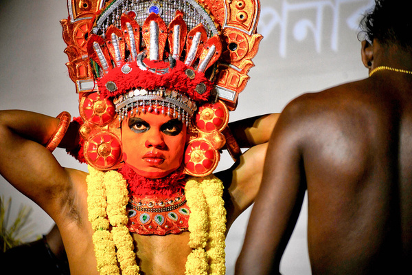 A Theyyam artist from Kerala prepares at the 66 Pally Durga Puja Committee in Kolkata during the Durga Puja celebration. Durga Puja, also called Durgotsava or Sharodotsav, is an annual Indian festival honoring the Hindu goddess Durga. During their celebration, the 66 Pally Club Durga Puja Committee showcased Kerala Tourism with performances of traditional Theyyam dances.