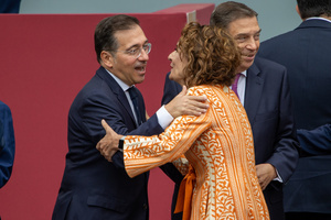 José Manuel Albares, Minister of Foreign Affairs, European Union and Cooperation and María Jesús Montero, First Vice President of the Government of Spain greet each other during the parade. During the Armed Forces parade on National Day led by King Felipe VI, Queen Letizia, their daughters Leonor de Borbón, Princess of Asturias and Infanta Sofía de Borbón.