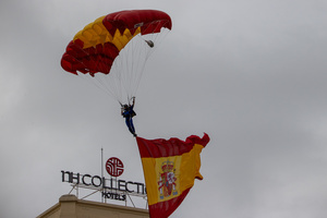 An Air Force paratrooper descends with a Spanish flag to kick off the parade. During the Armed Forces parade on National Day led by King Felipe VI, Queen Letizia, their daughters Leonor de Borbón, Princess of Asturias and Infanta Sofía de Borbón.