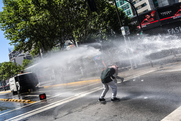 Police seen spraying water cannon at the protesters during a Mapuche march through the main streets of Santiago. March for Mapuche resistance, on Columbus Day, October 12, held in the city of Santiago.