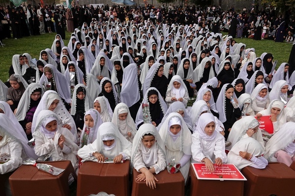 Muslim girls wearing headscarves are seen at a ceremony held in Diyarbakir. More than 300 young Muslim women attend an annual ceremony organised by the Prophet Lovers Foundation in the garden of the historic Prophet Suleyman Mosque, the ceremony which honors Muslim children and young girls covered with headscarves for the first time, as part of their faith. Speeches at the ceremony emphasize that covering one's body and head is a religious requirement for women, and they urge other young girls to do so