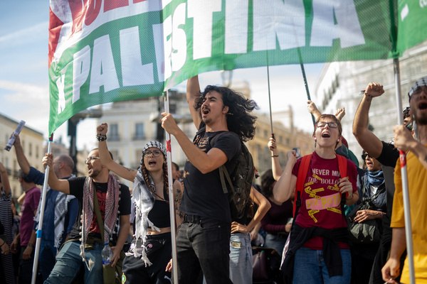 A group of pro-Palestinian protesters chant slogans during a general strike at Puerta del Sol, called by Spanish unions in solidarity with the Palestinians in Gaza.