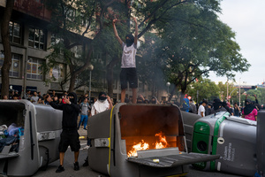 Burning dumpsters are seen during the demonstration. A nationwide strike was held all over Spain, with demonstration in all the main cities. More than 20.000 of pro-Palestinian protesters marched in Barcelona, with several clashes with police and episodes of looting and burning of dumpsters.