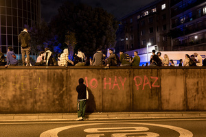 A person is seen writing " there's no peace" on a wall during the demonstration. A nationwide strike was held all over Spain, with demonstration in all the main cities. More than 20.000 of pro-Palestinian protesters marched in Barcelona, with several clashes with police and episodes of looting and burning of dumpsters.