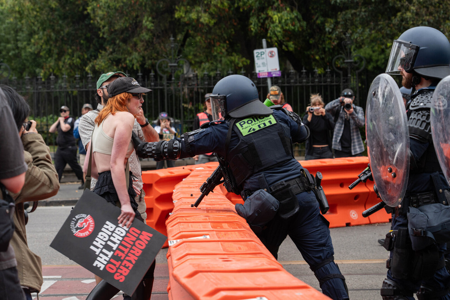 A riot police officer pushes a protester during the rally. A counter-rally opposing the “March for Australia” rally in Melbourne turned violent as clashes erupted between participants and police. Officers used pepper spray, rubber bullets, and flash bangs to control the crowd after fights broke out, with bins and Australian flags set on fire. Authorities reported one arrest following the unrest.