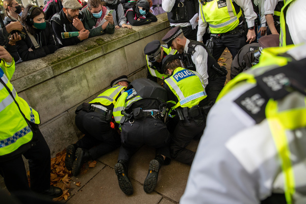 Metropolitan Police Officers arrest a trans activist who is suspected of breaking section 14 of the public order act. Trans activists held a counter protest in response to a feminist demonstration regarding the high court’s equalities act ruling which they describe as transphobic. Crowds gathered in Embankment Gardens before setting off towards Parliament Square escorted by Police.