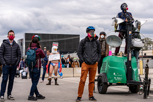 People look on during a demonstration in front of the Broadview Immigration Detention Facility. A lawsuit filed October 30, 2025 alleges inhumane, degrading, and humiliating conditions in the facility with a lack of food, water, access to hygiene and medical care, or places to sleep.