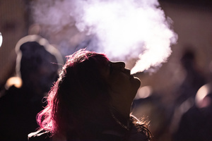 A demonstrator smokes in front of a police line outside the Broadview Immigration Detention Facility. A lawsuit filed October 30, 2025 alleges inhumane, degrading, and humiliating conditions in the facility with a lack of food, water, access to hygiene and medical care, or places to sleep.