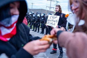 Demonstrators share a piece of Kentucky Fried Chicken in front of the Broadview Immigration Detention Facility. A lawsuit filed October 30, 2025 alleges inhumane, degrading, and humiliating conditions in the facility with a lack of food, water, access to hygiene and medical care, or places to sleep.