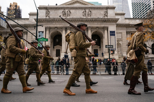 People dressed in American World War I uniforms march during the 106th annual Veterans Day Parade.