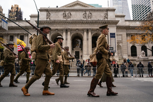 People dressed in American World War I uniforms march during the 106th annual Veterans Day Parade.