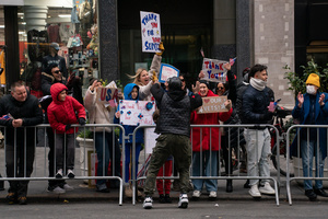 Spectators cheer on veterans as they march during the 106th annual Veterans Day Parade.