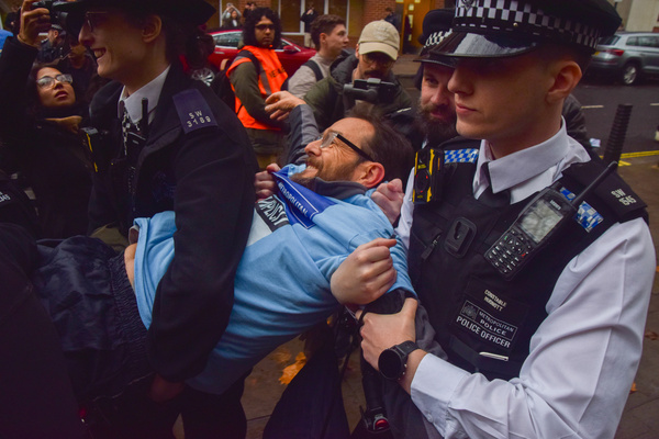 Police officers arrest a protester holding a placard in support of Palestine Action during the demonstration outside the Home Office. Dozens of people gathered to show support for the activist group, which has been banned under anti-terrorism laws, as part of the Lift The Ban campaign by the organization Defend Our Juries.