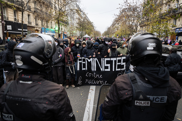 Antifascists demonstrators are seen in front of police officers of the BRAV-M squad during the march against gender-based and sexual violence. The Paris march against gender-based and sexual violence took place from Place de la République, organized by #NousToutes, Grève féministe, and other associations. This mobilization was part of the preparations for the International Day for the Elimination of Violence Against Women. Thousands of demonstrators—women, LGBTQIA+ individuals, and allies—came together to highlight the extent of gender-based and sexual violence in France: femicide, harassment, assault, according to the organizers judicial impunity.