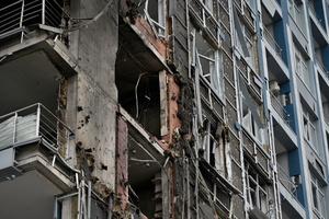 A damaged apartment building hit by a Russian drone strike amid Russia's attack.