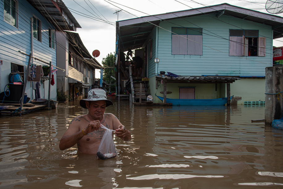 A man stands in floodwaters from the Chao Phraya River in front of his village at Ayutthaya. Ayutthaya flood was caused by heavy rainfall from tropical storms, which led to an increased discharge of water from the Chao Phraya Dam, overwhelming riverbanks in low-lying areas of the province.