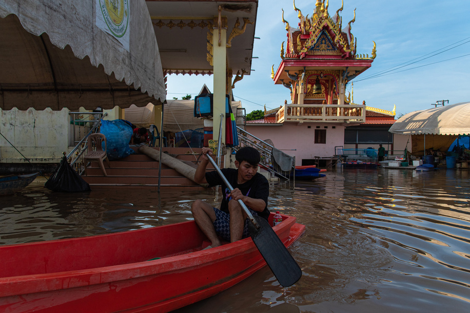A man paddles a plastic boat through floodwaters from the Chao Phraya River at the Buddhist temple in Ayutthaya. Ayutthaya flood was caused by heavy rainfall from tropical storms, which led to an increased discharge of water from the Chao Phraya Dam, overwhelming riverbanks in low-lying areas of the province.