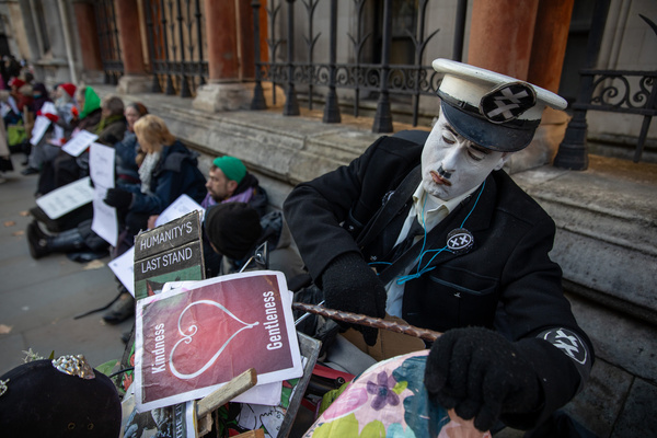 A group of pro Palestine Action supporters hold placards during a demonstration. Defend Our Juries continue the protest outside the Royal Courts of Justice in London. The activist group calls for the de-prescription of 'Palestine Action' as a terrorist organisation. Individuals held handwritten signs saying, “I support Palestine Action.” Activists were arrested and detained under the 2000 Terrorism Act.