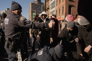 NYPD officer pepper sprays protestors who confronted Immigration and Customs Enforcement (ICE) agents during an attempted sweep on Canal Street in Manhattan. ICE has cracked down on vendors selling counterfit goods in New York City.
