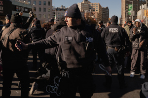 NYPD officer pepper sprays protestors who confronted Immigration and Customs Enforcement (ICE) agents during an attempted sweep on Canal Street in Manhattan. ICE has cracked down on vendors selling counterfit goods in New York City.