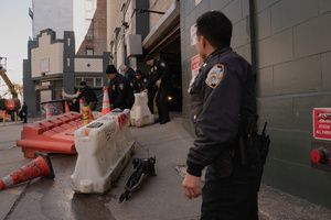 DHS officers clear a path for Immigration and Customs Enforcement (ICE) agents to leave the parking garage they staged at before an attempted sweep on Canal Street in Manhattan. ICE has cracked down on vendors selling counterfit goods in New York City.