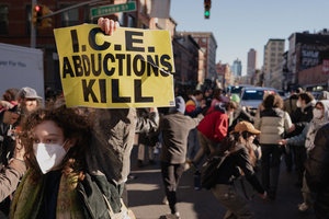 A protestor holds a "ICE Abductions Kill" placard as Immigration and Customs Enforcement (ICE) agents are confronted by protestors before an attempted sweep on Canal Street in Manhattan. ICE has cracked down on vendors selling counterfit goods in New York City.