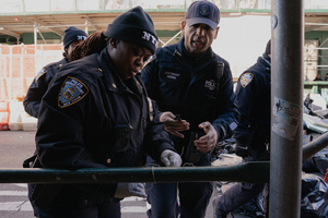 NYPD officers clear a makeshift road block made to halt Immigration and Customs Enforcement (ICE) agents from a sweep on Canal Street in Manhattan. ICE has cracked down on vendors selling counterfit goods in New York City.