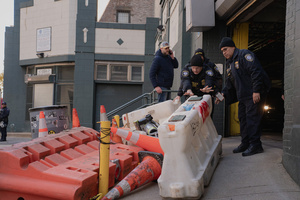 DHS officers clear a path for Immigration and Customs Enforcement (ICE) agents to leave the parking garage they staged at before an attempted sweep on Canal Street in Manhattan. ICE has cracked down on vendors selling counterfit goods in New York City.