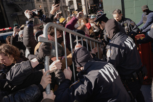 NYPD officers use a barricade to push protestors that confronted Immigration and Customs Enforcement (ICE) agents before an attempted sweep on Canal Street in Manhattan. ICE has cracked down on vendors selling counterfit goods in New York City.
