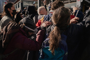 An older woman holds onto protestors that confronted Immigration and Customs Enforcement (ICE) agents before an attempted sweep on Canal Street in Manhattan. ICE has cracked down on vendors selling counterfit goods in New York City.