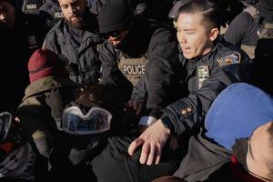 Immigration and Customs Enforcement (ICE) agents are confronted by protestors before an attempted sweep on Canal Street in Manhattan. ICE has cracked down on vendors selling counterfit goods in New York City.