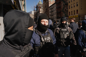 Immigration and Customs Enforcement (ICE) agents clear the entrance of the parking garage they rallied at before an attempted sweep on Canal Street in Manhattan. ICE has cracked down on vendors selling counterfit goods in New York City.
