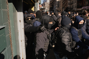 Immigration and Customs Enforcement (ICE) agents clear the entrance of the parking garage they rallied at before an attempted sweep on Canal Street in Manhattan. ICE has cracked down on vendors selling counterfit goods in New York City.