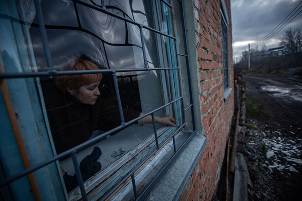 A resident removes a piece of glass from her window frame damaged by a Russian drone strike in Sumy. The Russian army attacked Sumy several times with drones. Part of the city was left without electricity or water due to the attacks on energy infrastructure. One of the drones hit a nearby residential building and the explosion shattered the windows of several apartments.