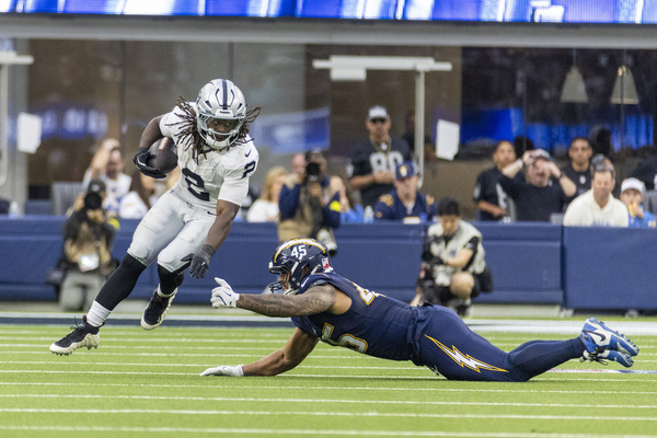 Las Vegas Raiders running back Ashton Jeanty #2 escapes a tackle-attempt by Los Angeles Chargers outside linebacker Tuli Tuipulotu #45 during an NFL football game at SoFi Stadium, Sunday Nov. 30, 2025, in Inglewood, Calif.