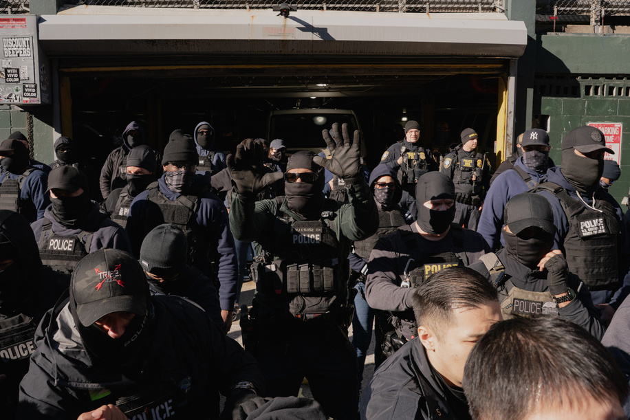 Immigration and Customs Enforcement (ICE) agents clear the entrance of the parking garage they rallied at before an attempted sweep on Canal Street in Manhattan. ICE has cracked down on vendors selling counterfit goods in New York City.